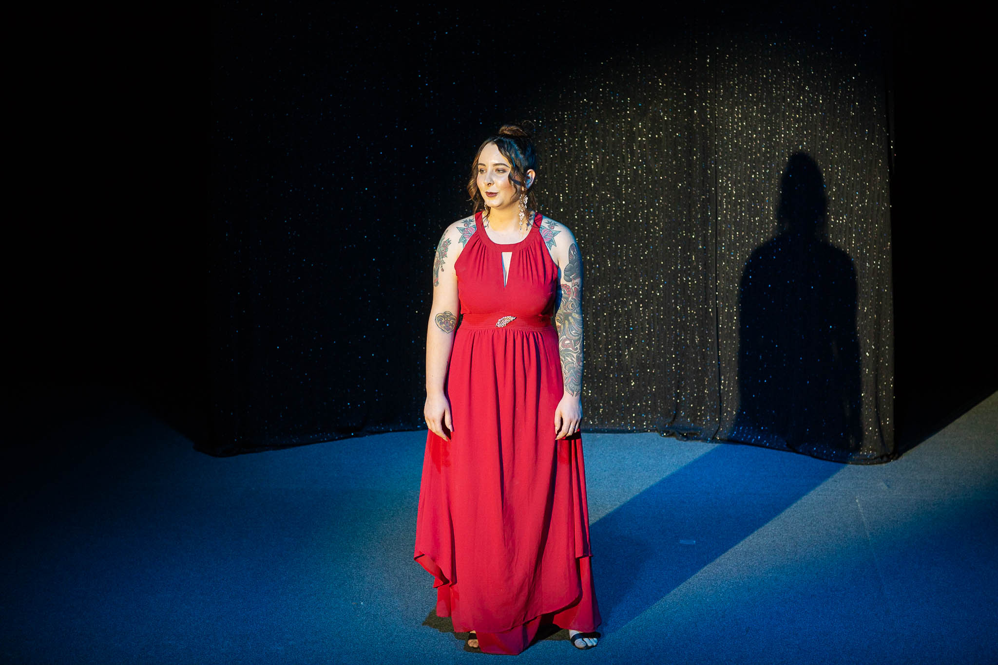 Photo of Woman in red dress in the spotlight. Photography by Caro Telfer, Photographer 